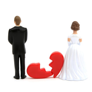 Husband and wife with broken heart between them representing divorce