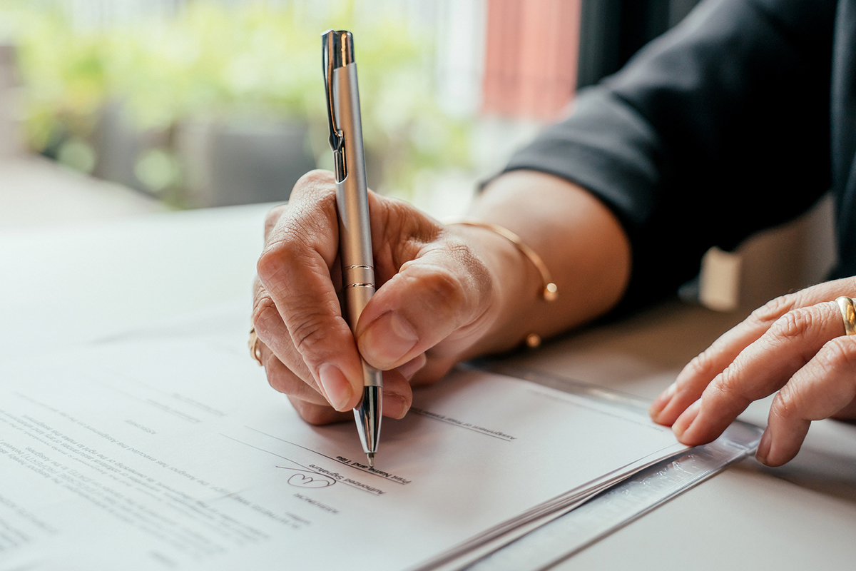 Lasting Power of Attorney document with solicitor advising client, Coodes Solicitors Cornwall